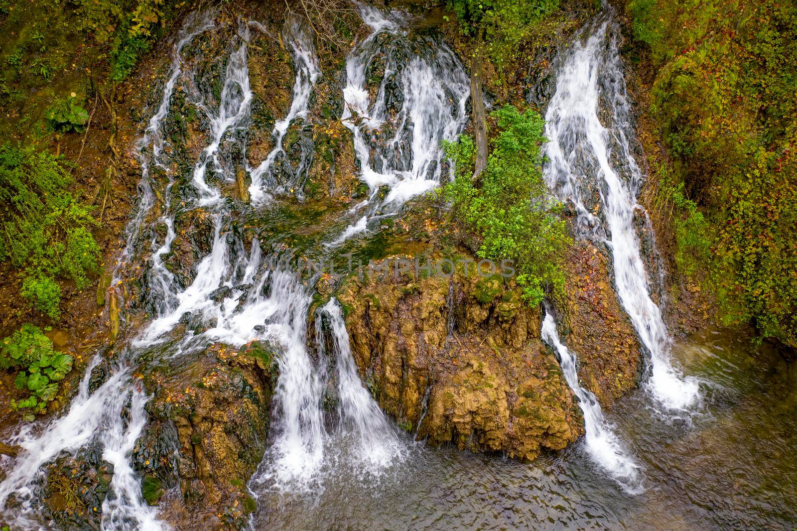 Waterfall in nature. Mountain cascade river waterfall. Aerial drone view by EdVal