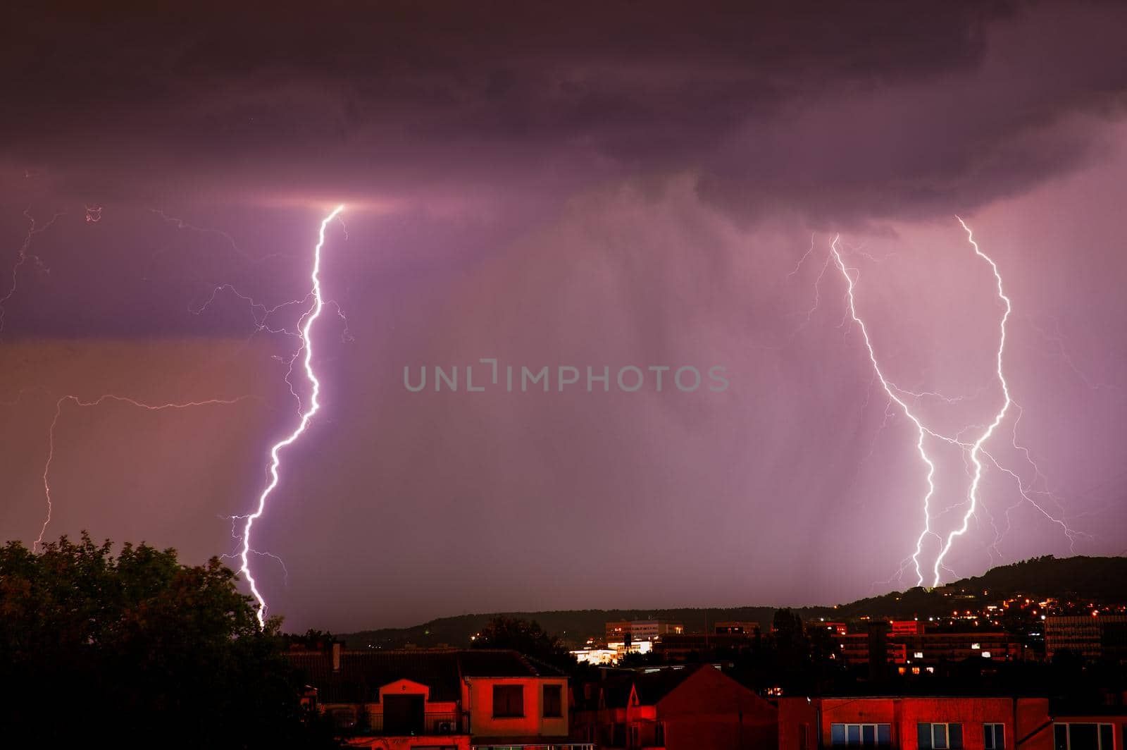 Exciting powerful flashes of lightning over the city, zipper and thunderstorm