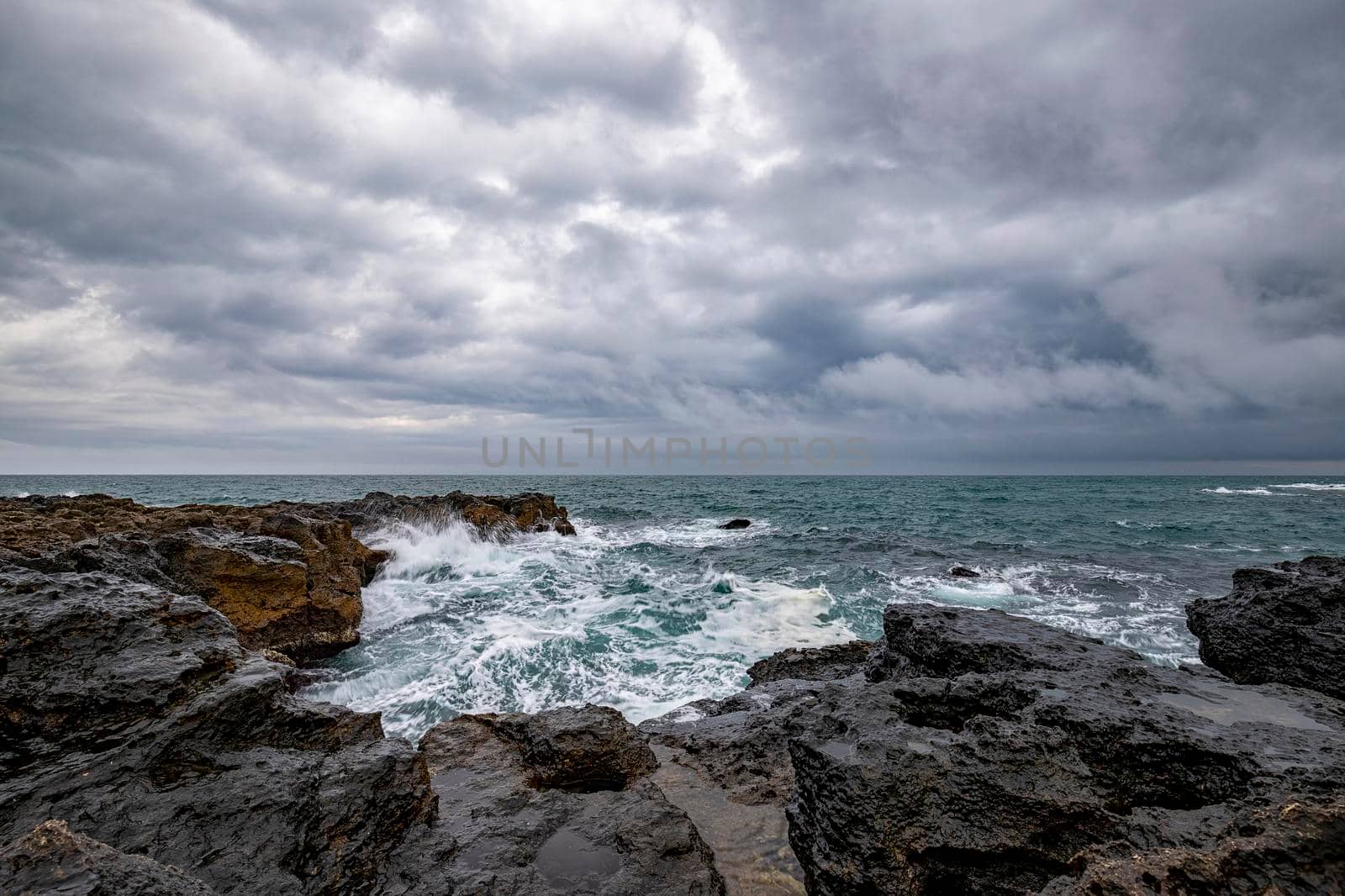 Stunning seascape with scenic clouds over the sea with rocky shore by EdVal