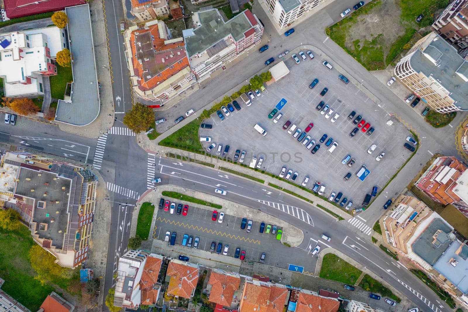 Aerial view from drone of a city road junction and car parking by EdVal
