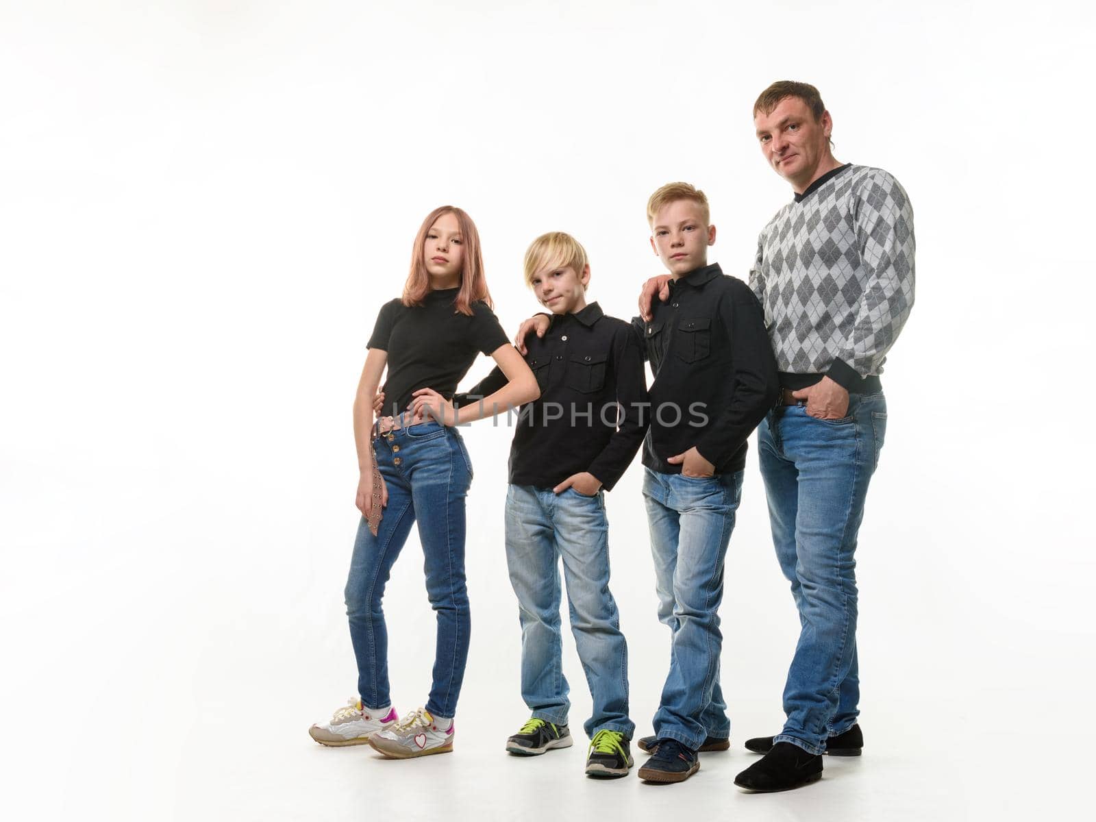 Dad, two sons and daughter in casual clothes in dark colors, full length portrait, white background