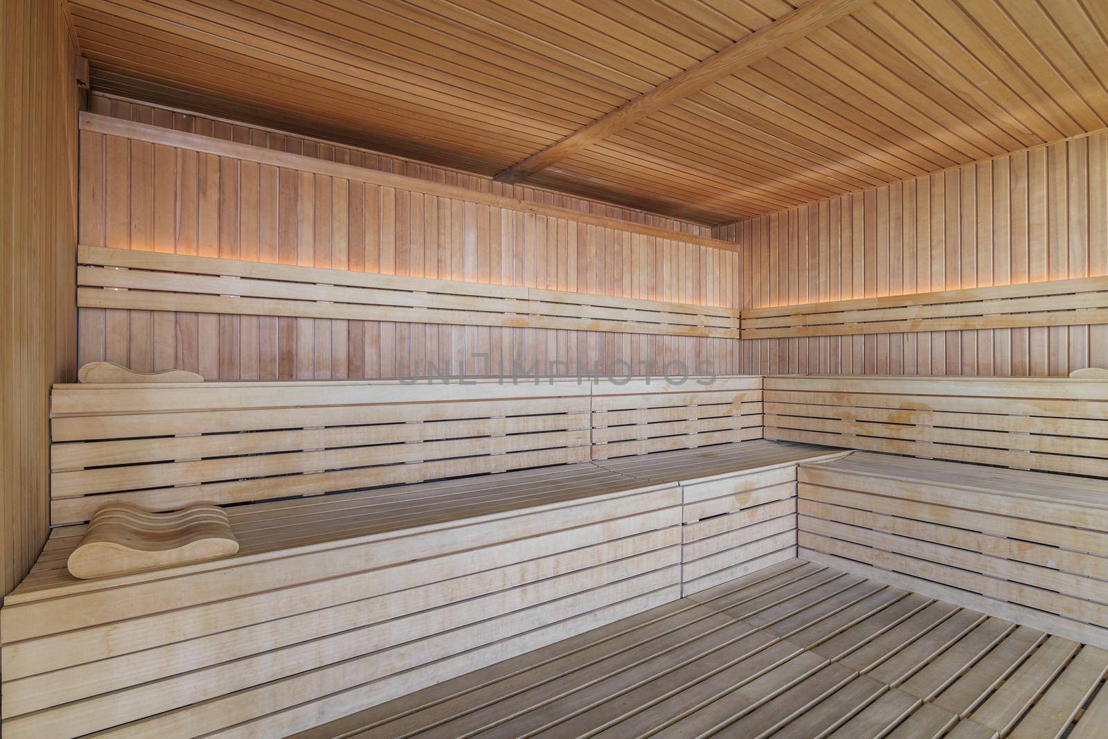 Empty Finnish sauna room. Modern interior of wooden spa cabin with dry steam.