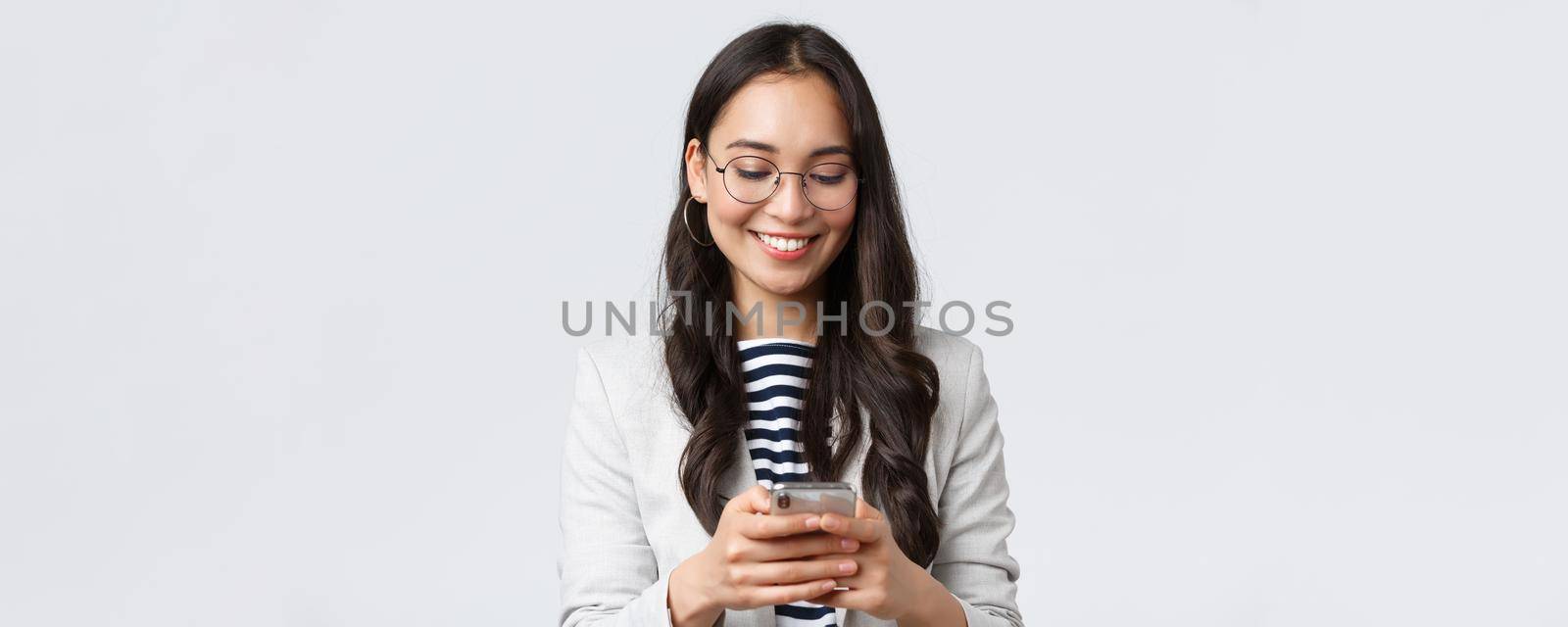 Business, finance and employment, female successful entrepreneurs concept. Attractive modern businesswoman messaging, using taxi app as head meeting with clients, white background.