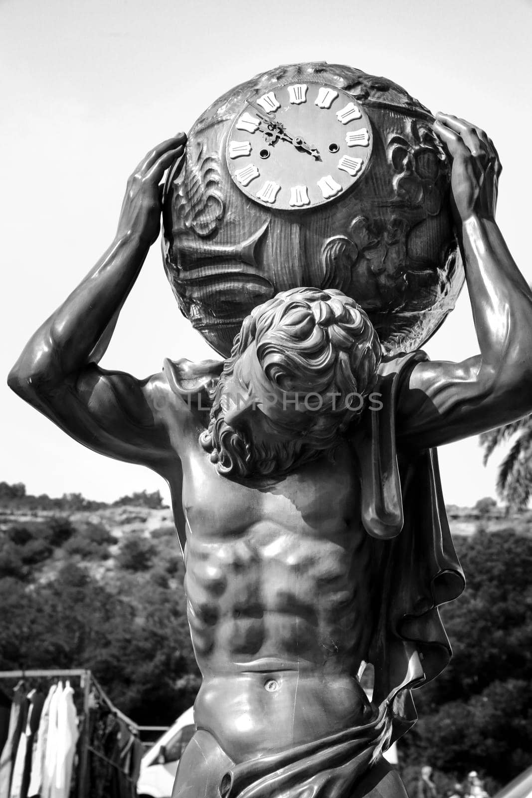 Guardamar, Alicante, Spain- April 3, 2022: Wooden atlas clock for sale at an antiques flea market called El Fogon in Guardamar