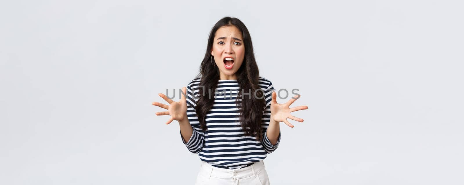 Lifestyle, people emotions and casual concept. Freak-out asian woman in panic, gesturing complaining and looking annoyed, Girl losing temper after touch day at work, having huge trouble.