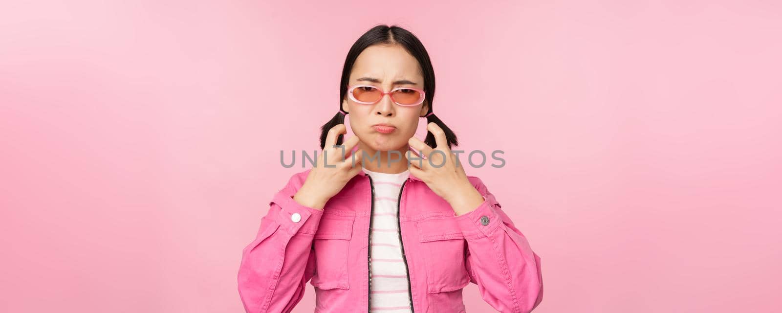 Image of angry, pissed off korean adult female model, shaking fists and shouting, screaming outraged, standing over pink background by Benzoix