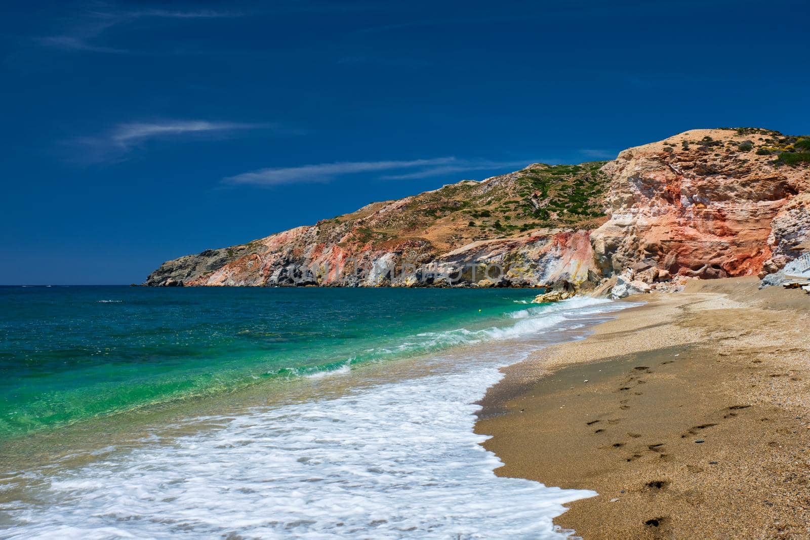 Greek beach in Greece view - Paleochori beach and waves of Aegean sea, Milos island, Cyclades, Greece. Slow motion