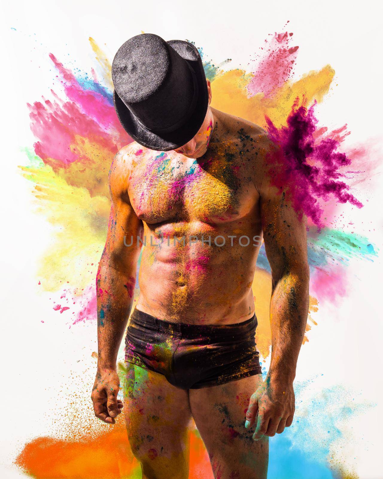 Muscular man shirtless with skin painted with Holi colors by artofphoto