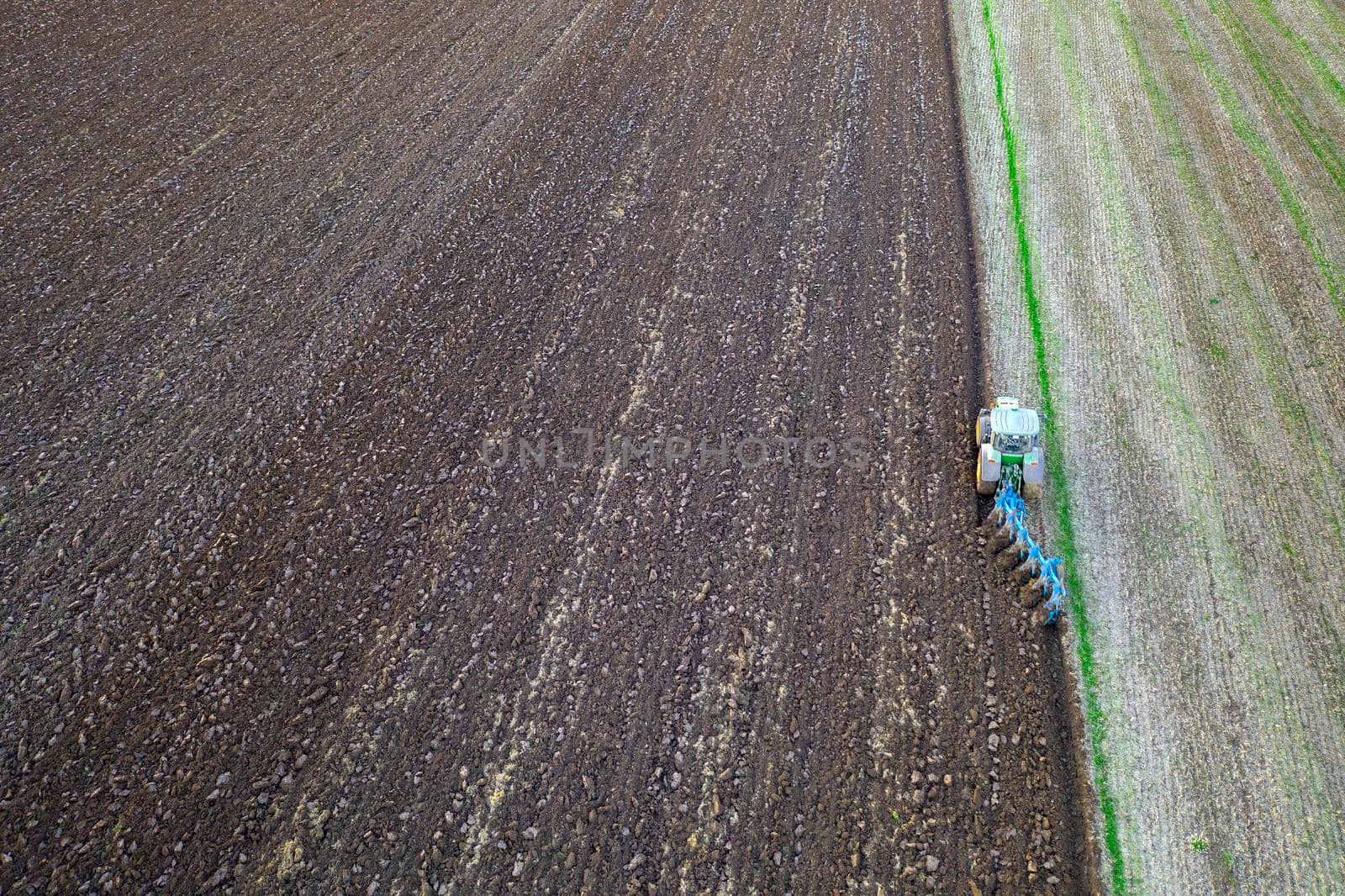 Agriculture. Agriculture. Tractor working in the field. Aerial view. Tractor plowed field. Copy space. by EdVal