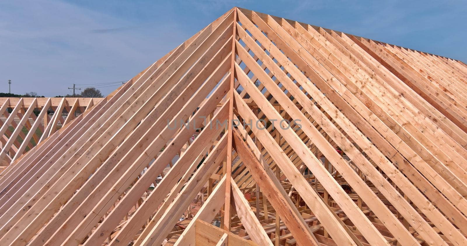 Newly built wooden skeleton frame of house roof section view in construction site