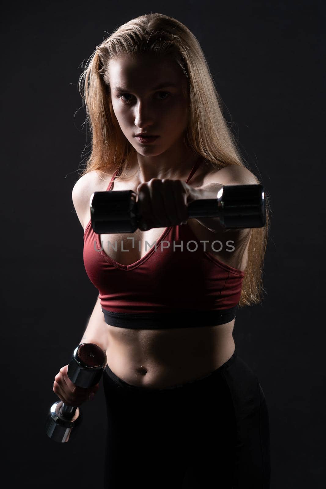 In kira dumbbells holds knightly beautiful a as her shiny hands girl dumbbells fitness caucasian, from female woman from healthy and bodybuilding isolated, beautiful people. Care ABS