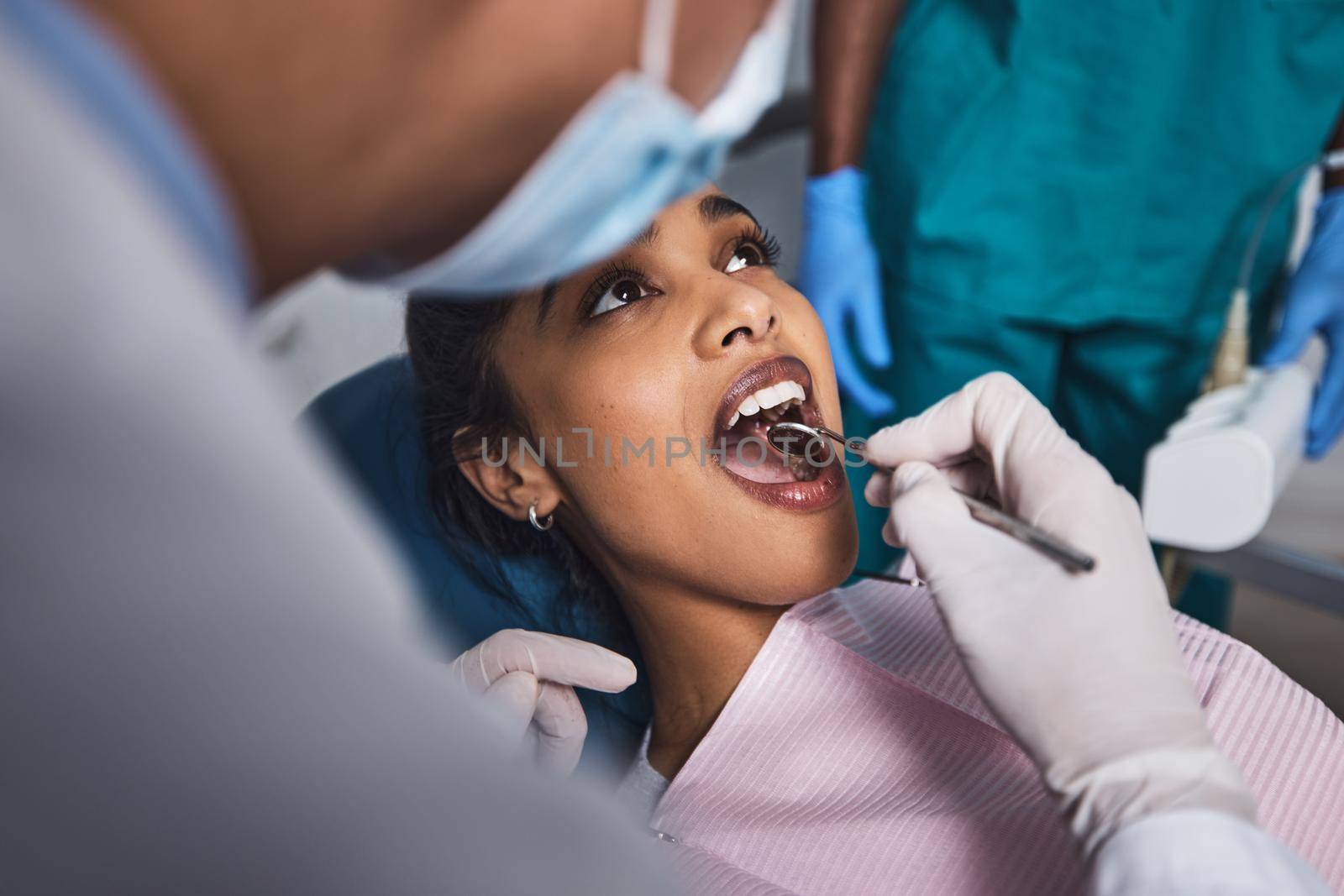 Its time to start smiling again. Shot of a young woman having dental work done on her teeth. by YuriArcurs