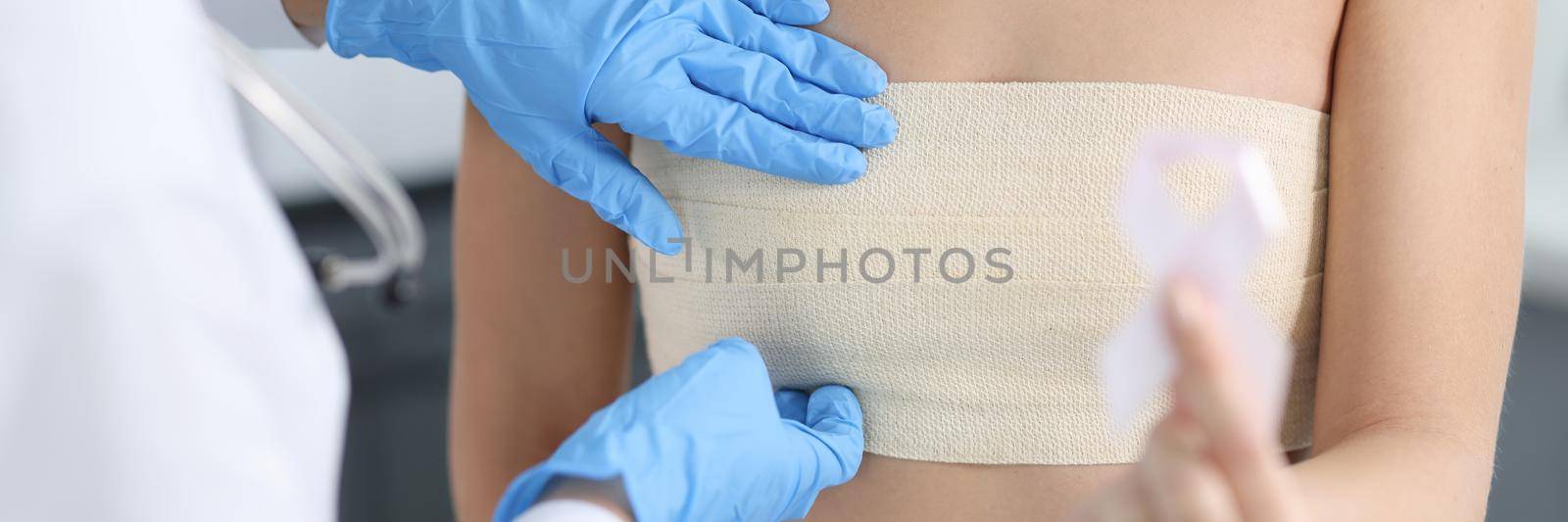 Doctor mammologist examining breast of female patient with elastic bandage closeup by kuprevich