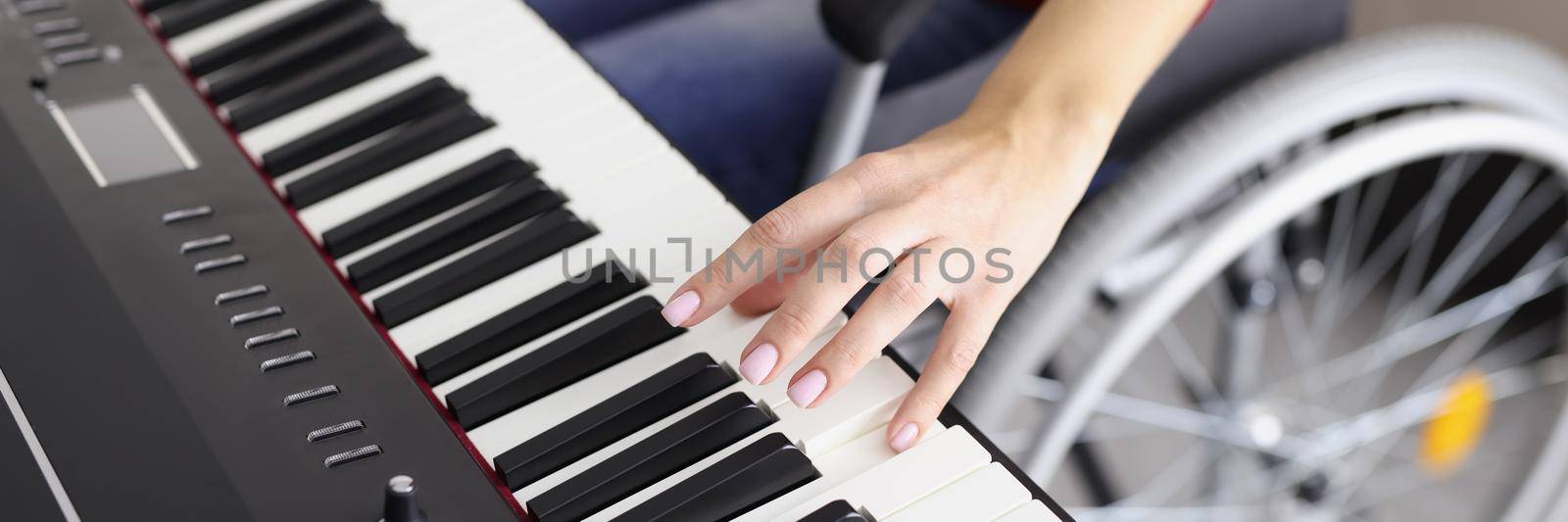 Close-up of woman playing piano sitting in wheelchair, disabled people around us, creative development, find hobby for soul. Healthcare, artist, medicine, art, music concept