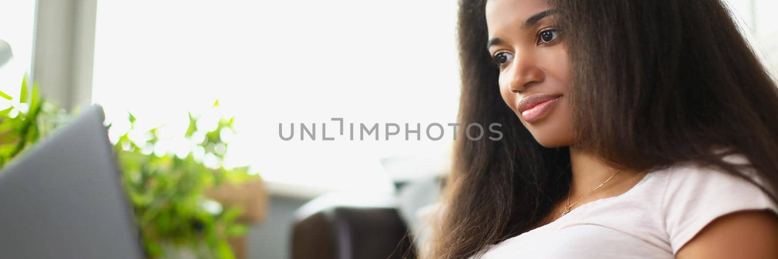 Portrait of concentrated latino american young woman working on laptop. Girl typing on keyboard preparing for exam in university. Technology, education, remote job, pastime