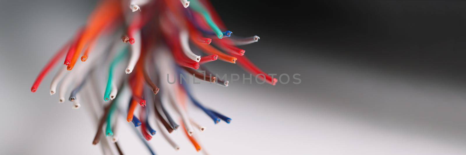 Close-up of large group of copper wires, electric screened power cables, colourful wires used in telecommunication, connect internet access. Electricity concept. Blurred background