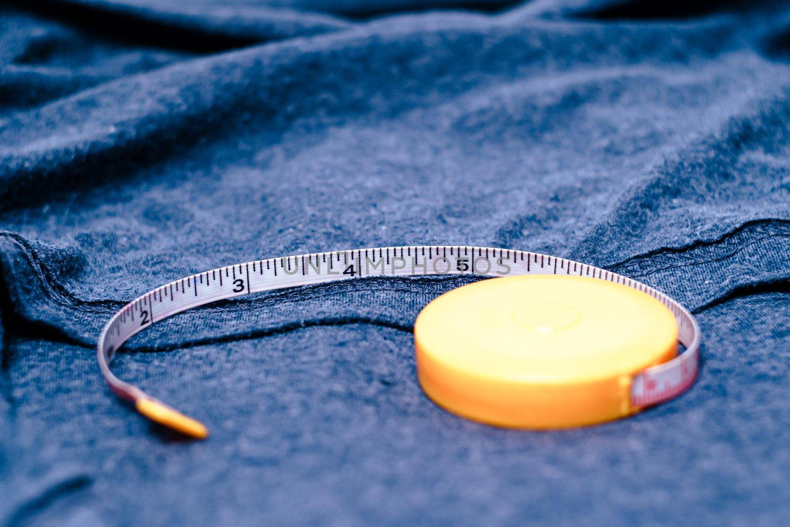 Measuring tape on the cotton cloth material with a blue color