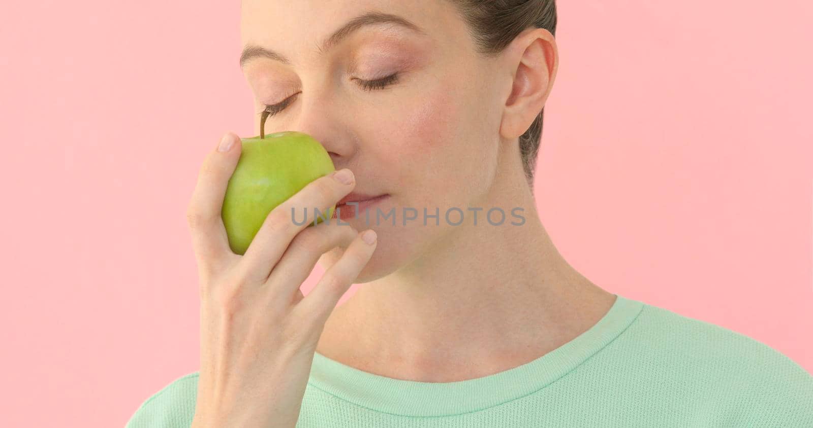 Beautiful girl enjoys smell apple by Demkat