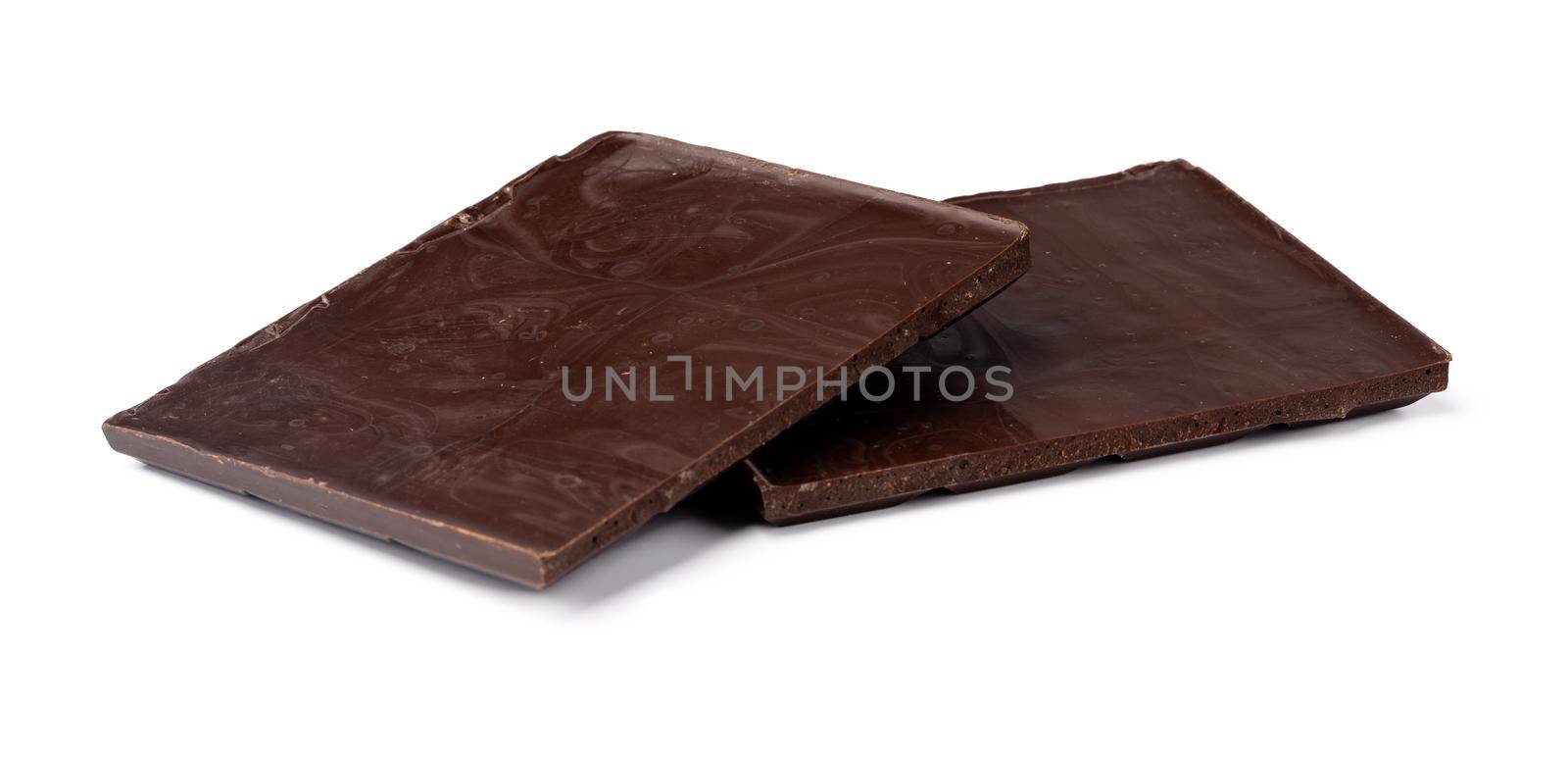 Small dark chocolate pieces isolated on white background, close up