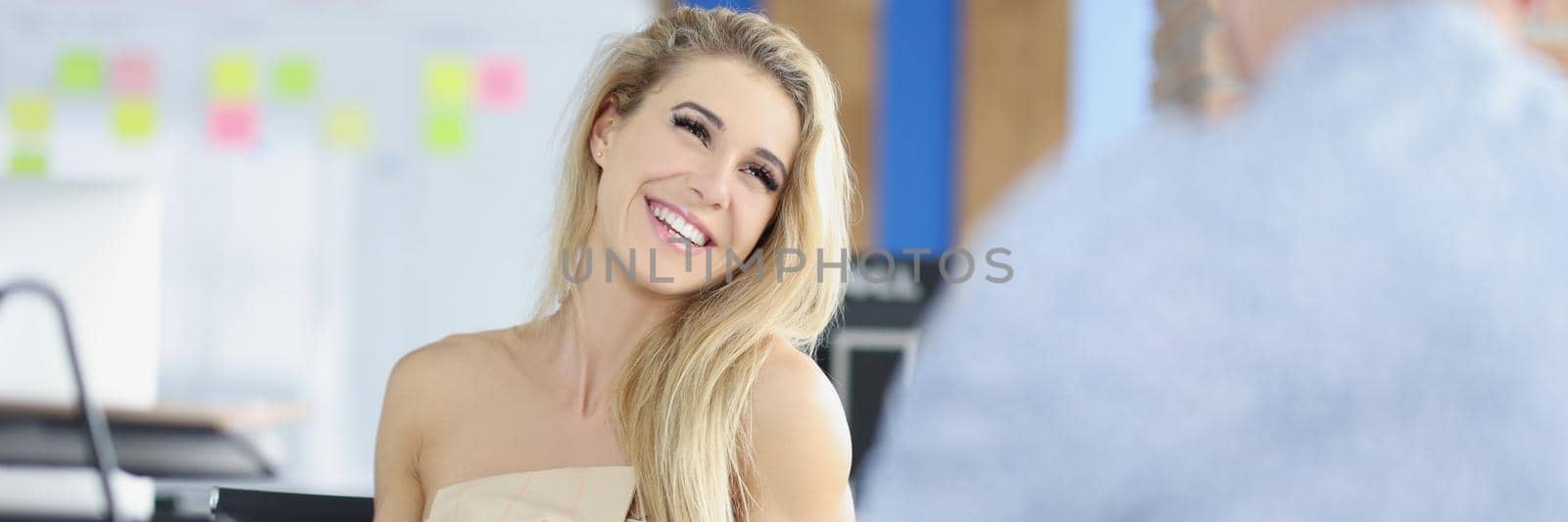 Portrait of blonde attractive woman sitting on boss place, control big corporation, female leader. Businesswoman interviewing person for work. Business, job, company concept
