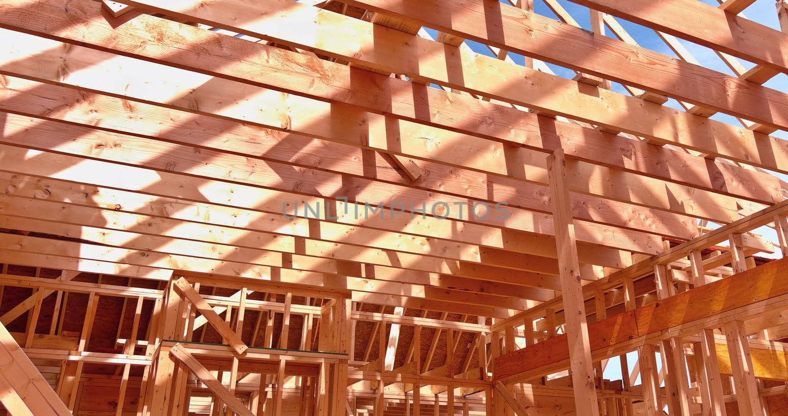 Installation of wooden with roof beams frame trusses condominium construction framework