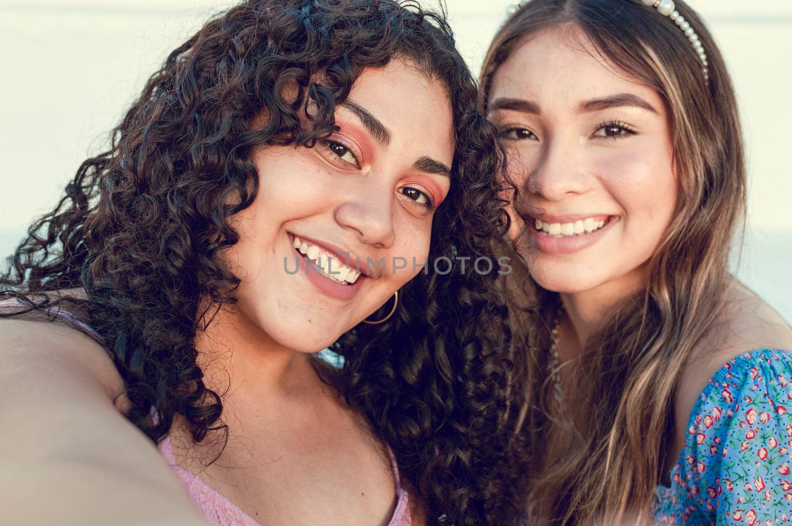 Close up of two cute girls taking a selfie, smiling girls taking a self portrait, Selfie of two girls