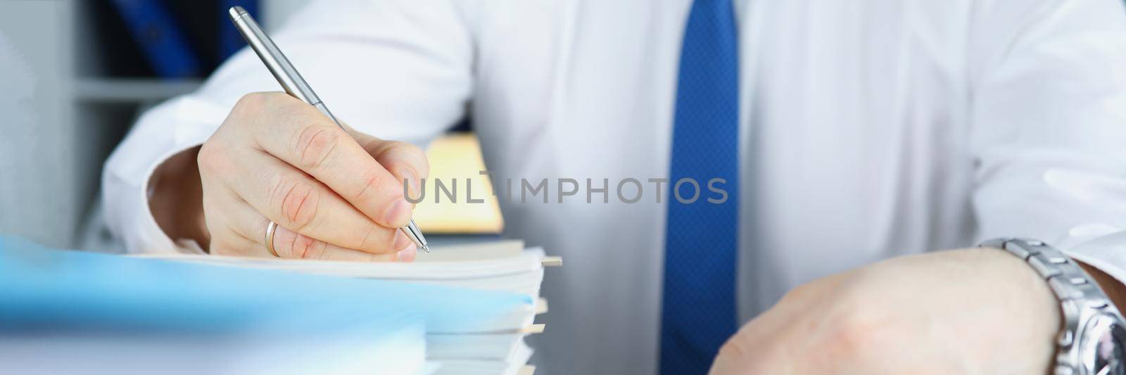 Employee in suit with stack of papers by kuprevich