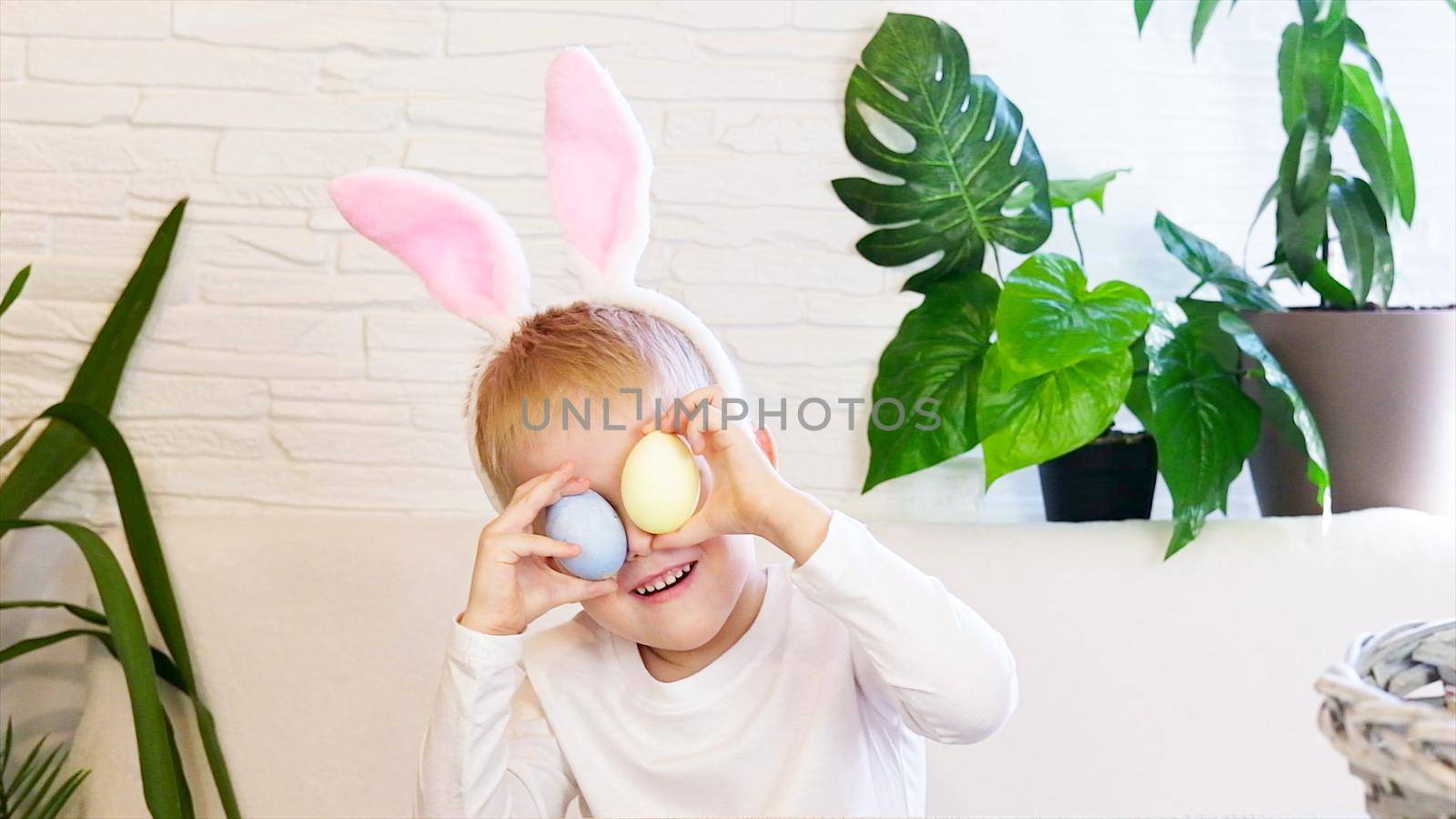 Funny happy child boy with easter eggs and bunny ears dancing. Easter concept, happy childhood. Easter Egg Hunt. Slow motion. by chelmicky