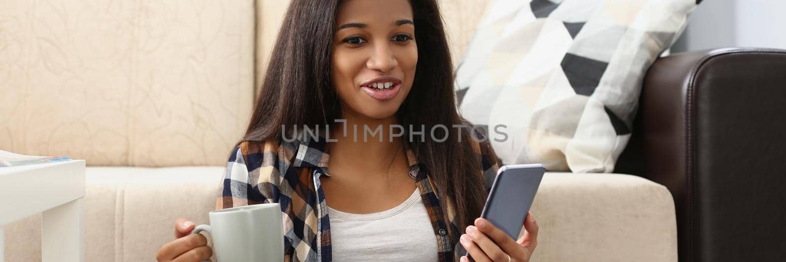 Portrait of woman surprised with end of movie, watching film online on website, open laptop on lap. Female record voice message to friend, hold smartphone in hand. Leisure, rest concept