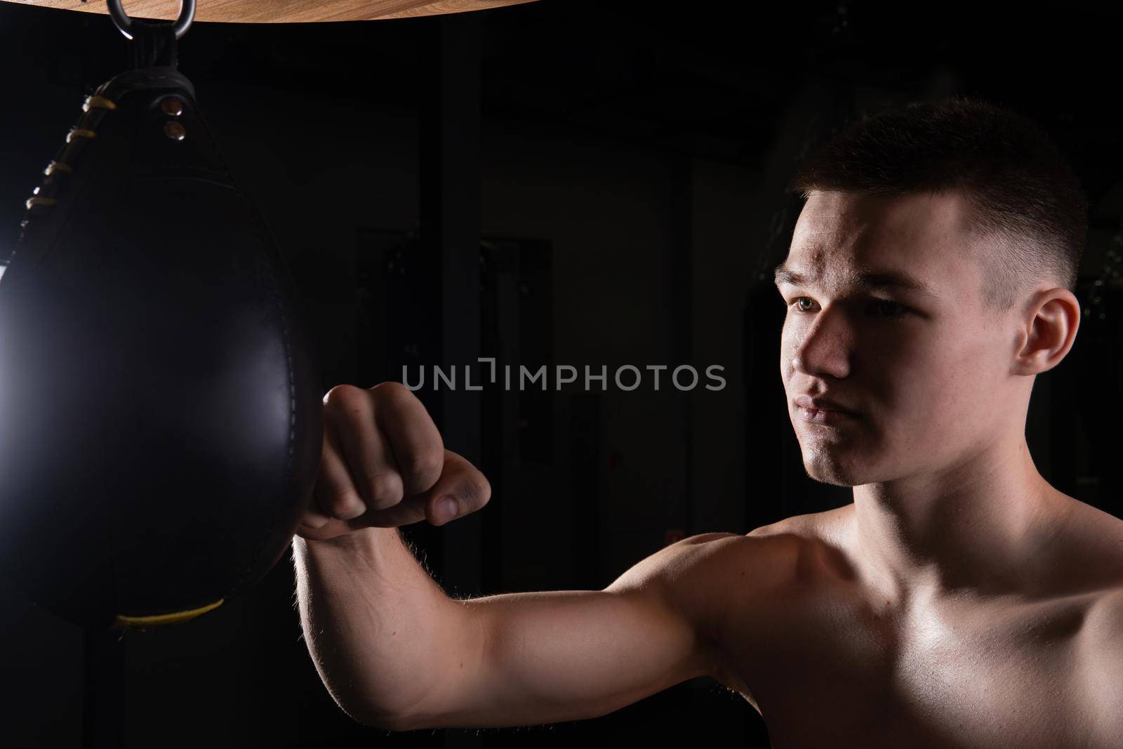 Practices The boxer the blows bag athlete glove black young background boxing, from strong muscle for punch from caucasian hit, shadow martial. Athletic victory people, fitness