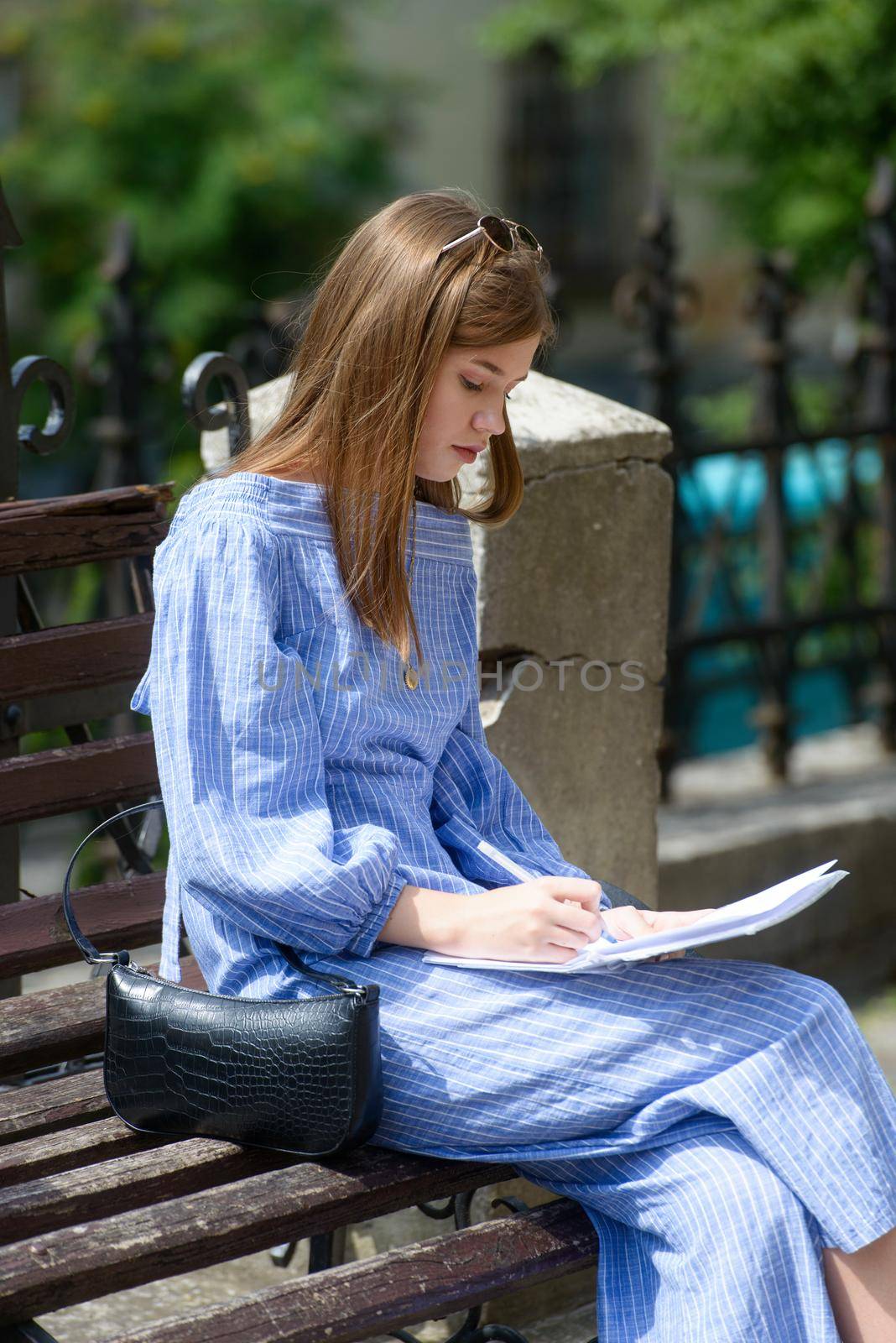 Female hand with pen completing personal information on form. by Ashtray25