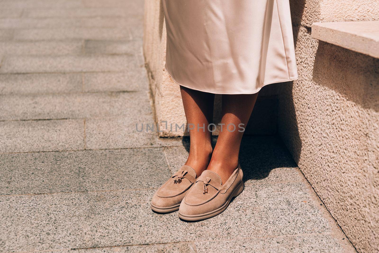 Portrait of fashionable women in beige dress posing in the street by Ashtray25