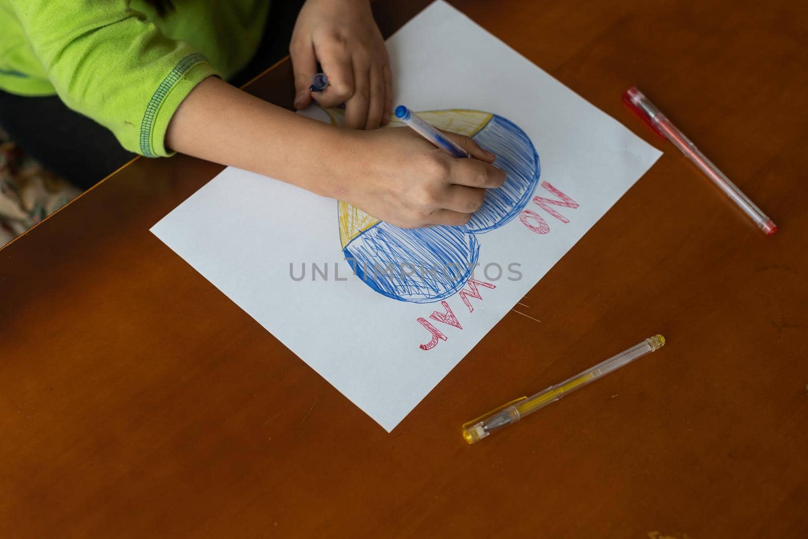 children's drawing, flags of ukraine are drawn on a sheet, children's hands hold a heart made, war between countries, peace concept.