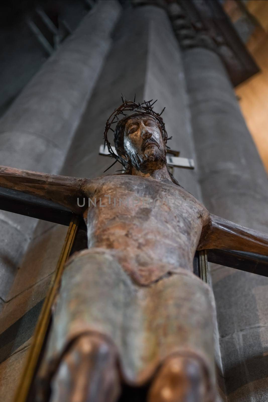 A statue of Jesus hanging on a cross in a church