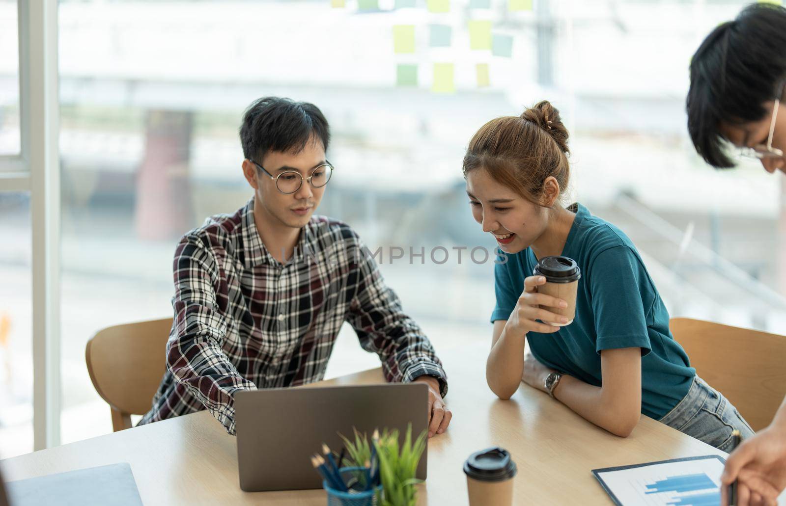 Young Asian woman leading business creative team in mobile application software design project. Brainstorm meeting, work together, internet technology, girl power, office coworker teamwork concept.