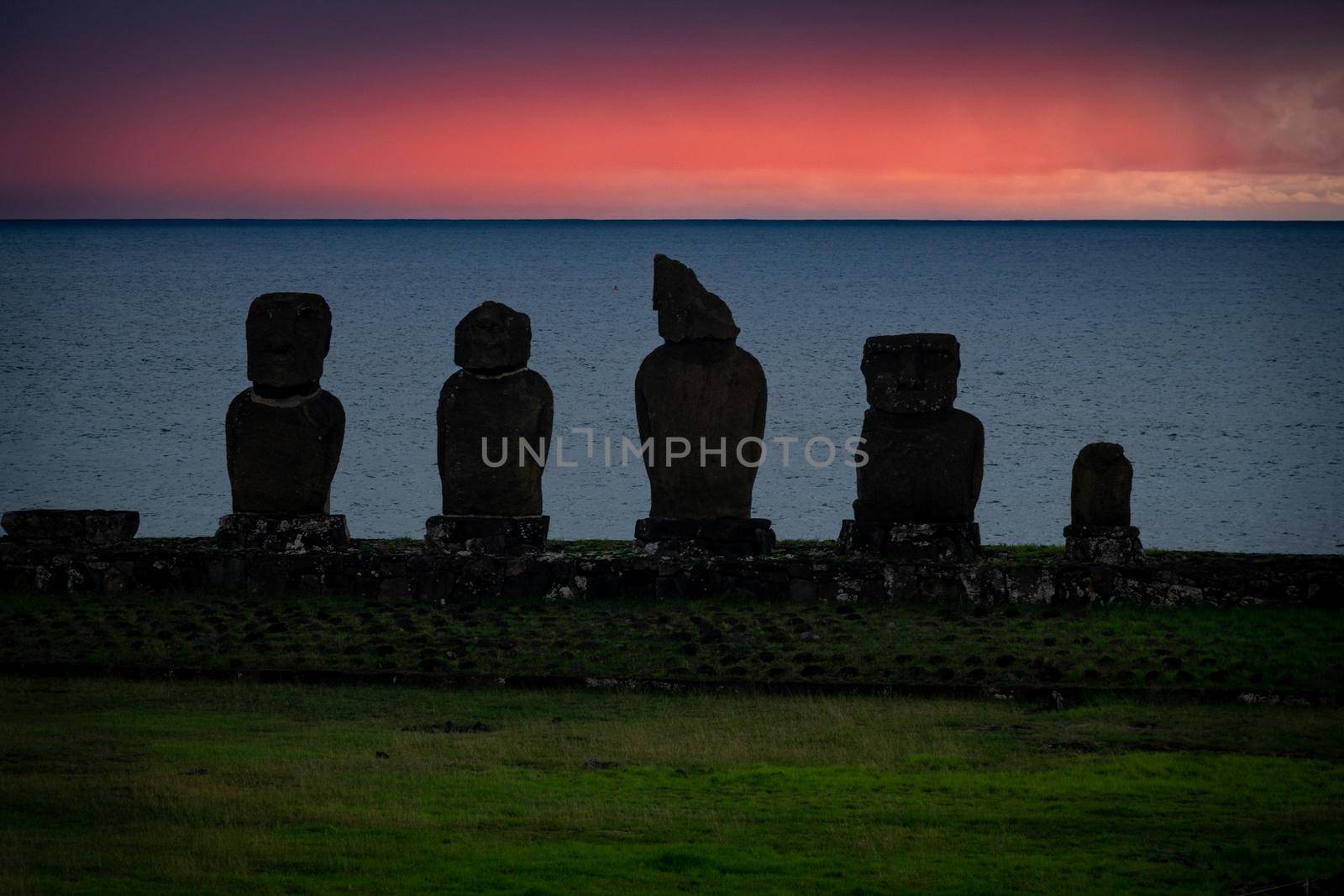 Ahu Tahai Moai shilouette during the sunset against pink sky, Easter Island, Chile, South America