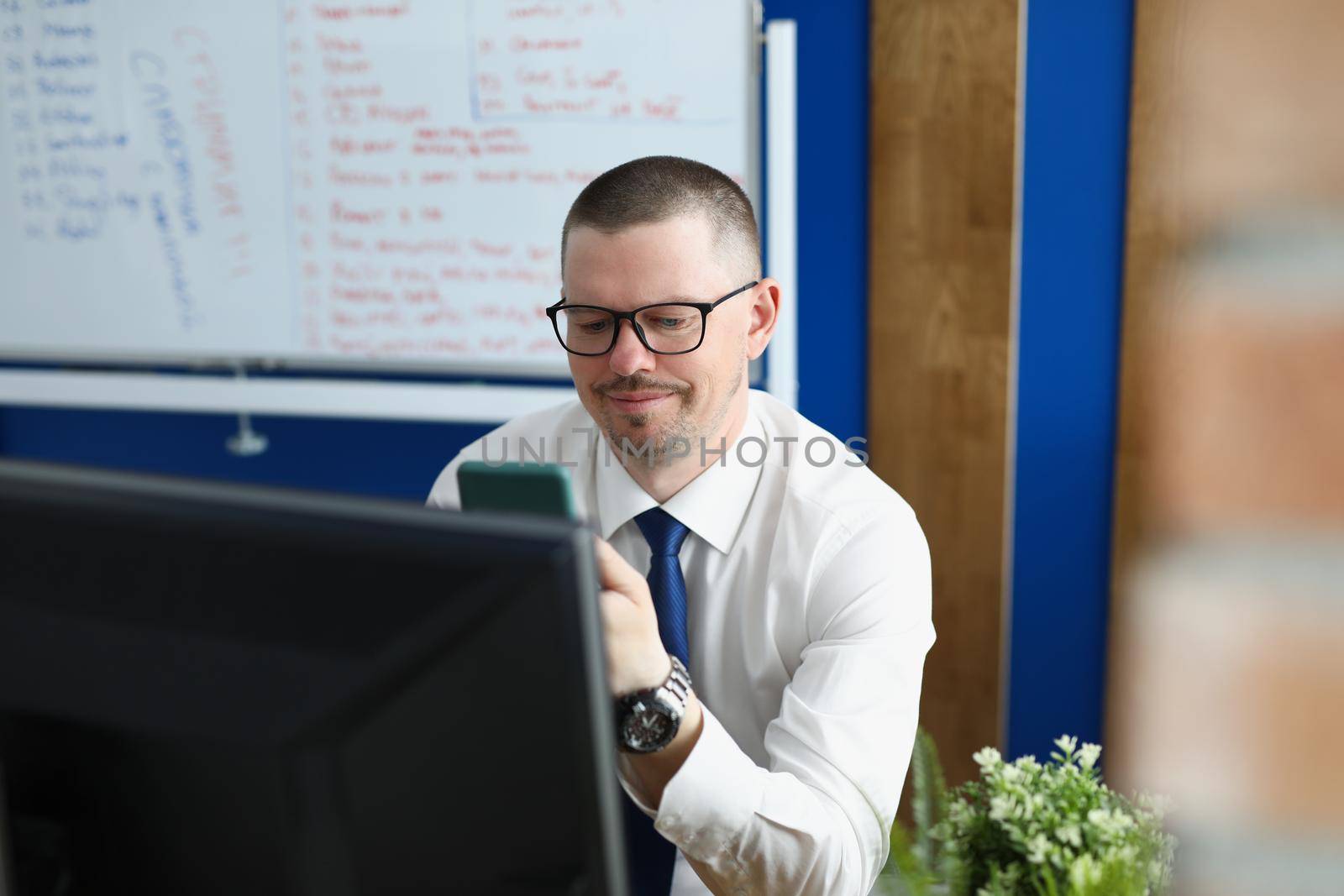 Employee in suit use phone by kuprevich