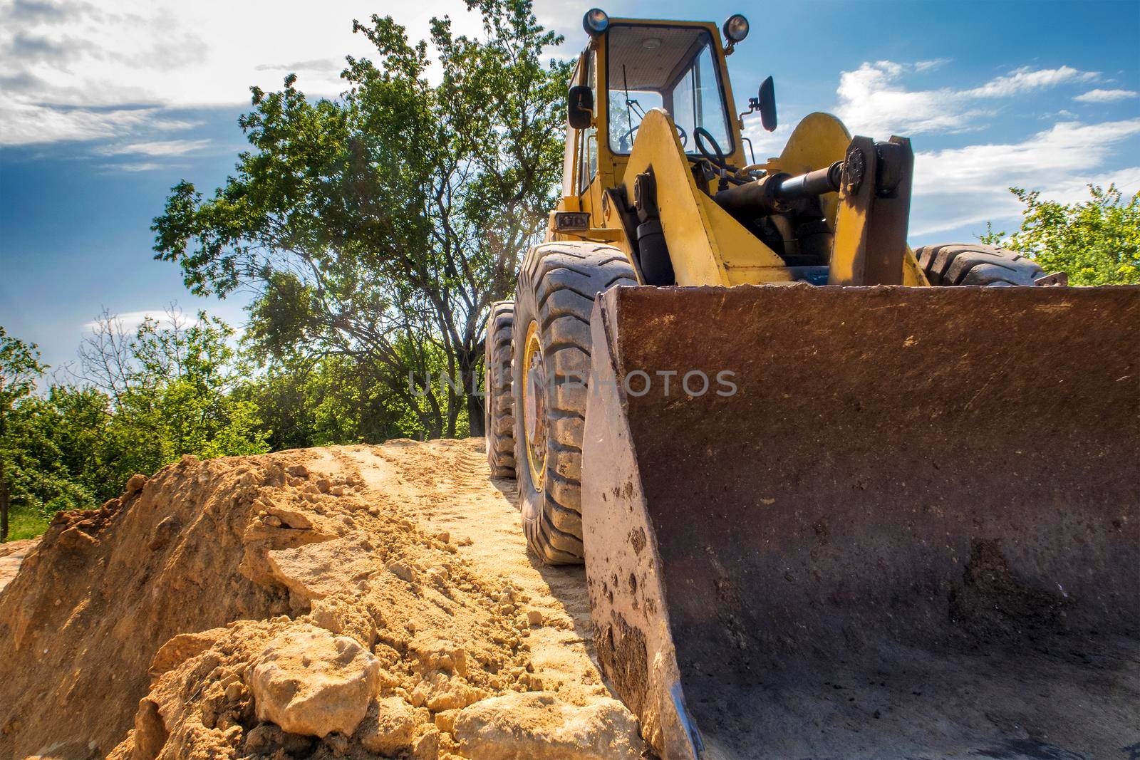 Close up of a big bucket of a yellow excavator  by EdVal