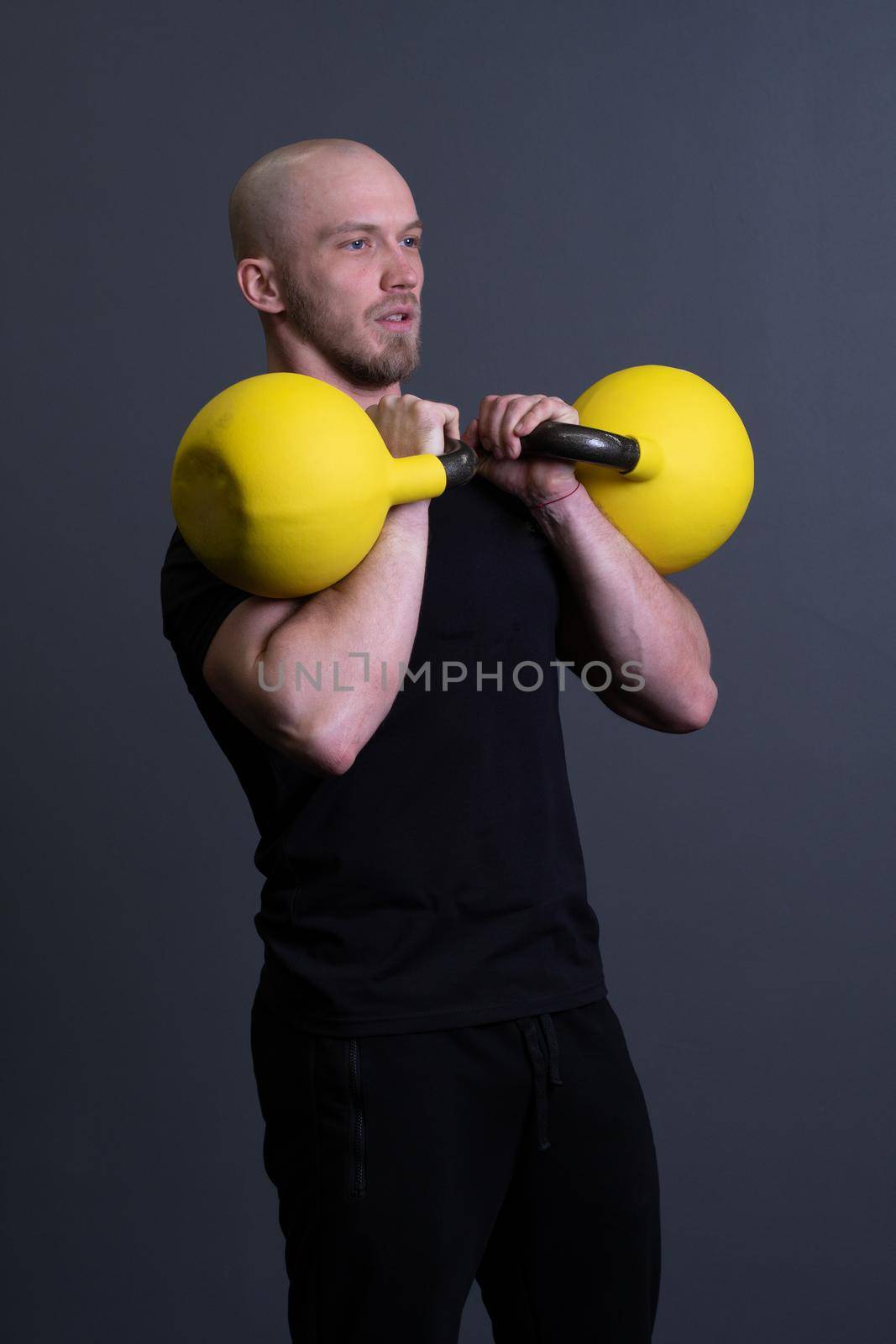 Guy with a yellow kettlebell gym anonymous workout strength, from fit lifestyle for men and up sportive, vietnamese filipino. Healthy interval health, cross hiit