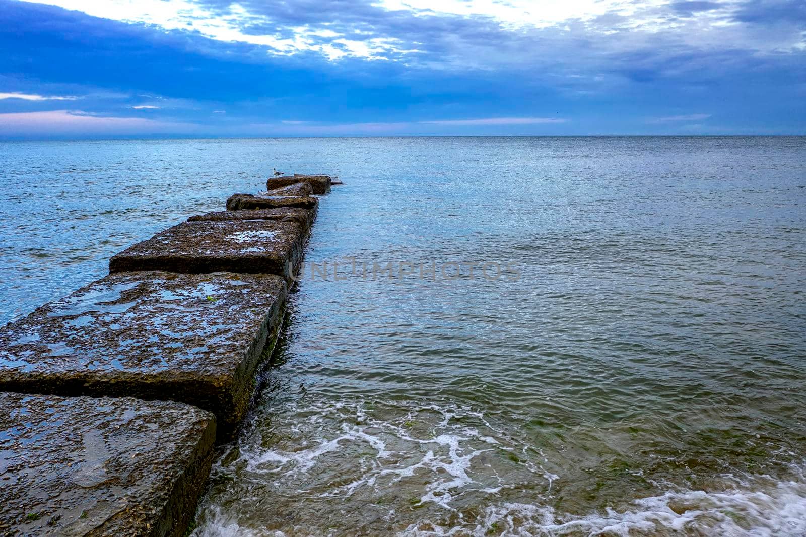 Beauty daily view with clouds of seashore with stone pier and clear water