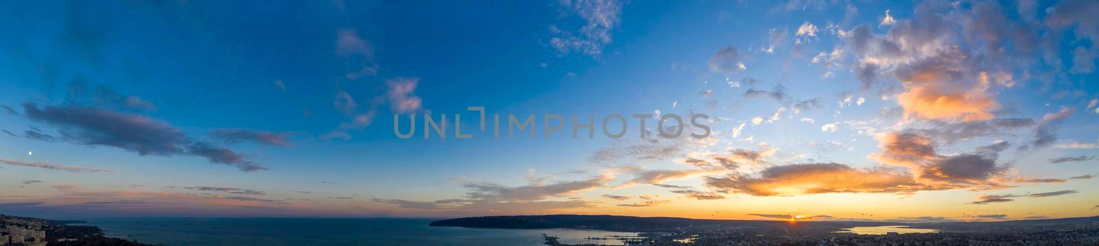 Panoramic view of the amazing sunset sky over the sea.