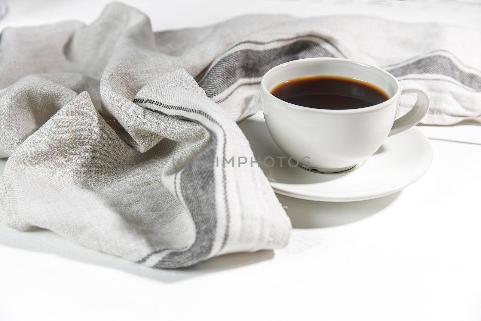 Cup of tea with napkin on white background by elenarostunova