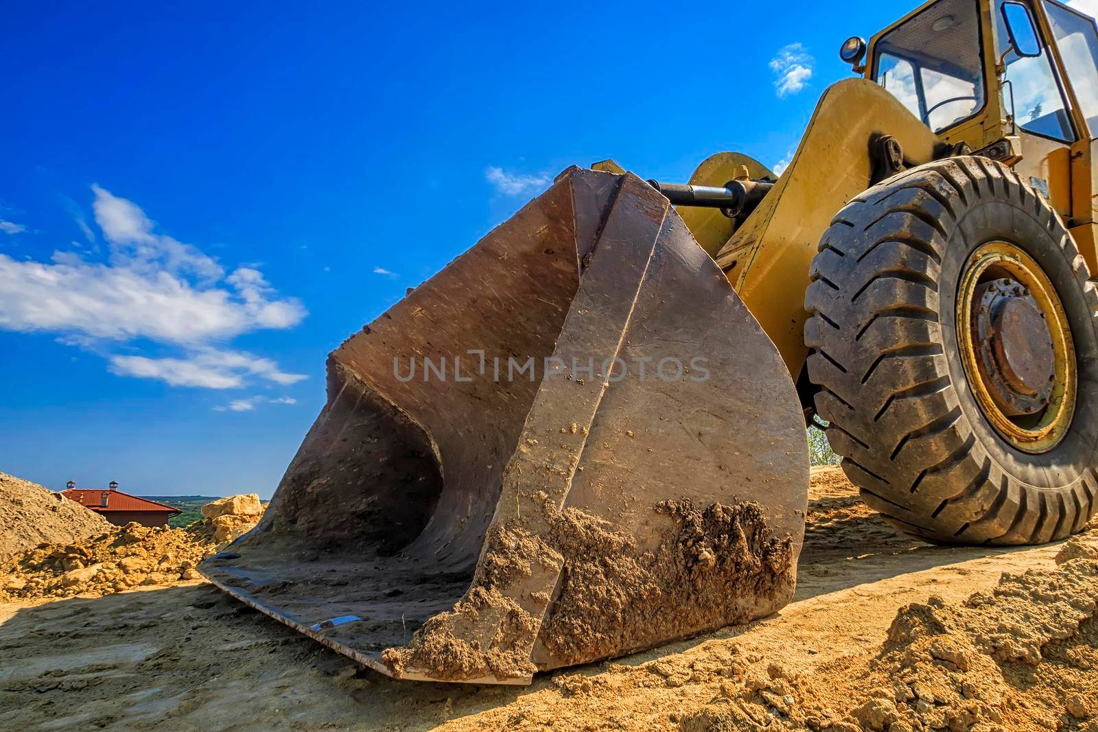 Close up of a big bucket of a yellow excavator  by EdVal