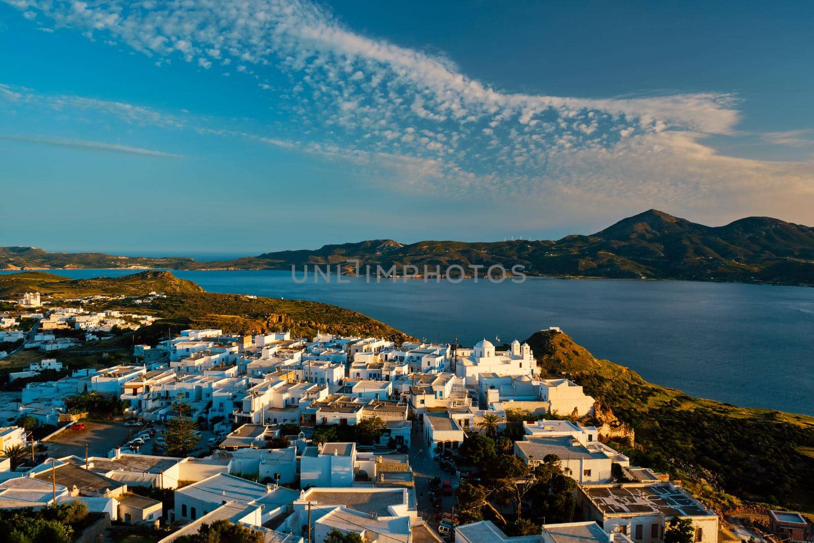 View of Plaka village on Milos island on sunset in Greece by dimol