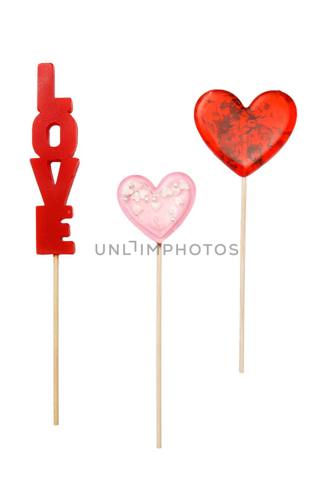 red heart shaped lollipop with herbs and pink star lollipop inside on a stick isolated on white. Gift for Valentine's Day. square format