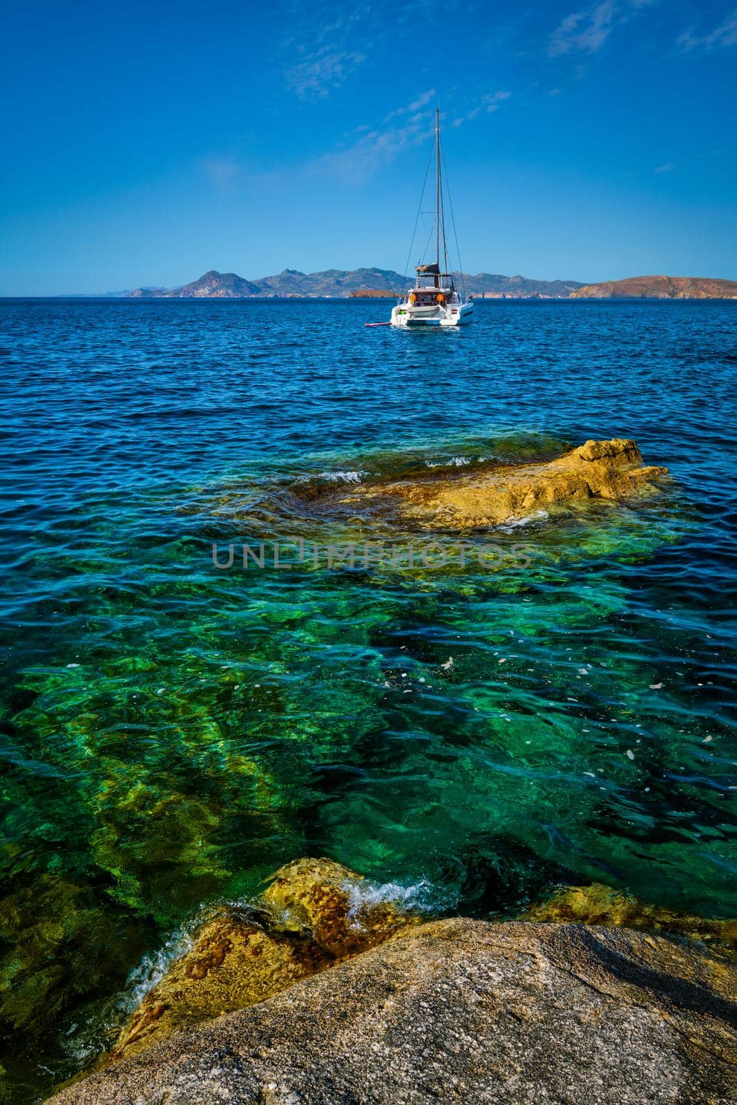 Yacht boat in Aegean sea at white rocks of Sarakiniko Beach, Milos island , Greece