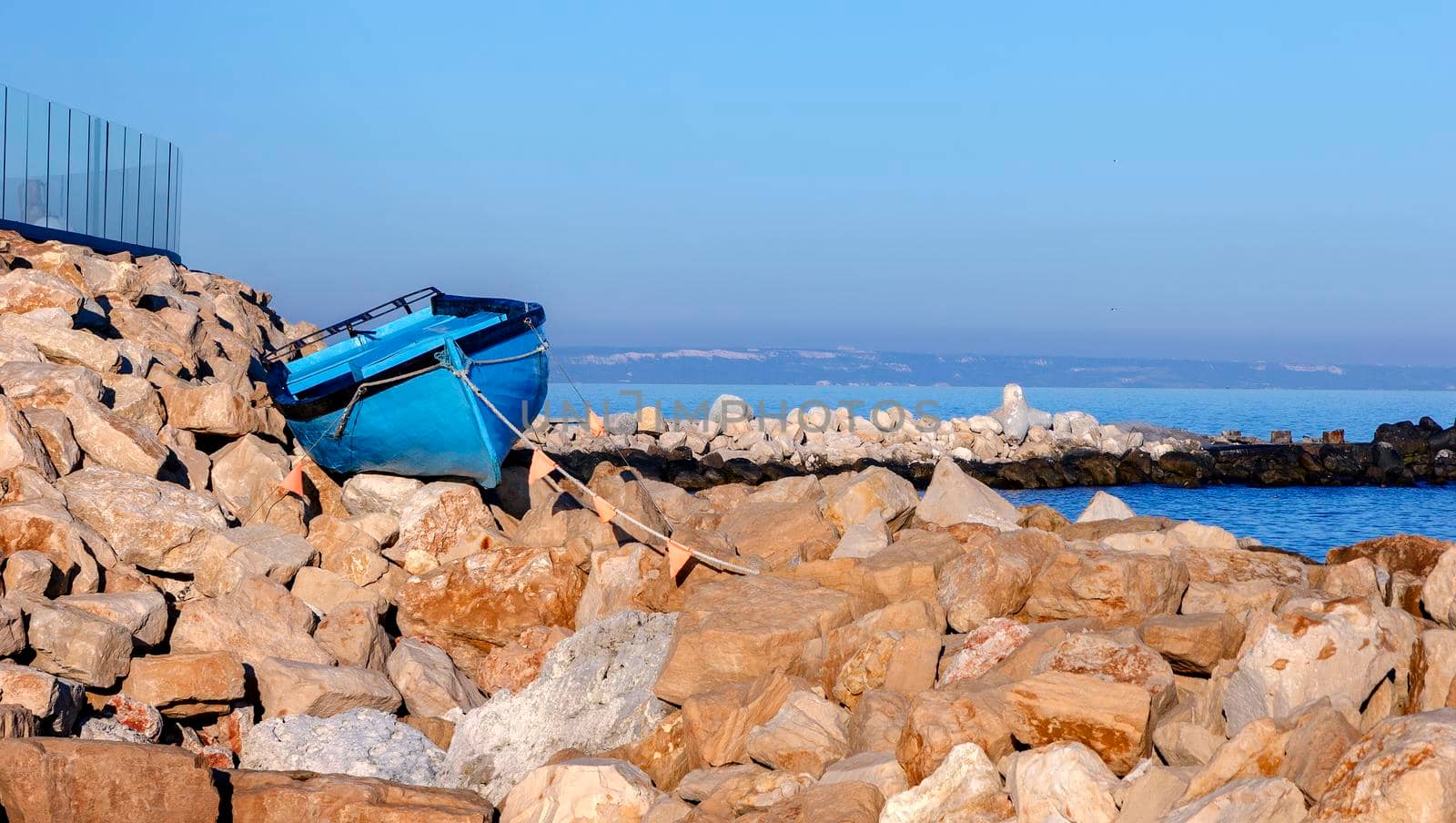 Parked Boat on the rocks on the beach