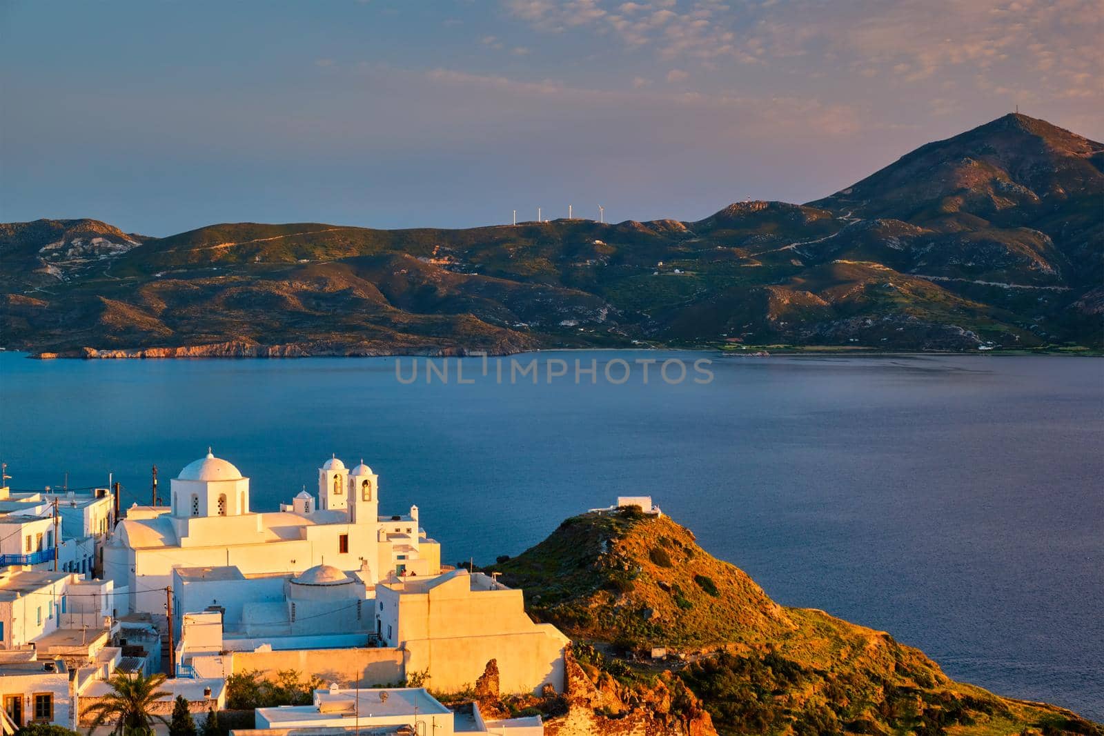 View of Plaka village on Milos island on sunset in Greece by dimol