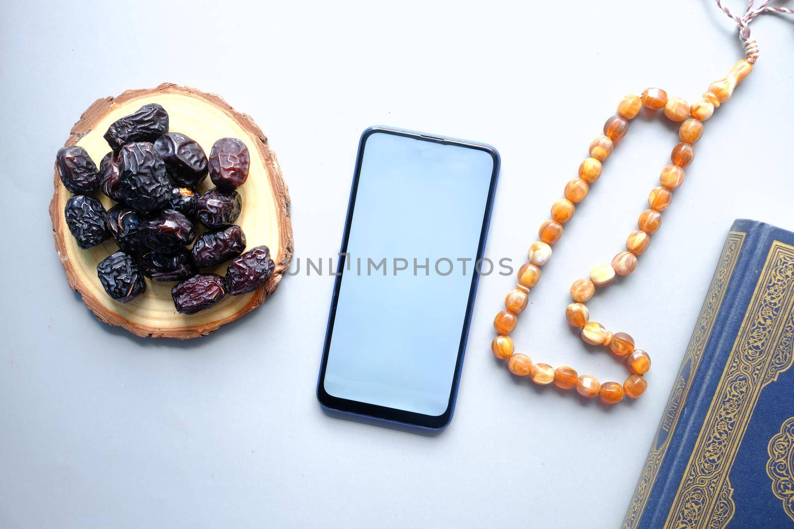 Holy book Quran and rosary on table, close up