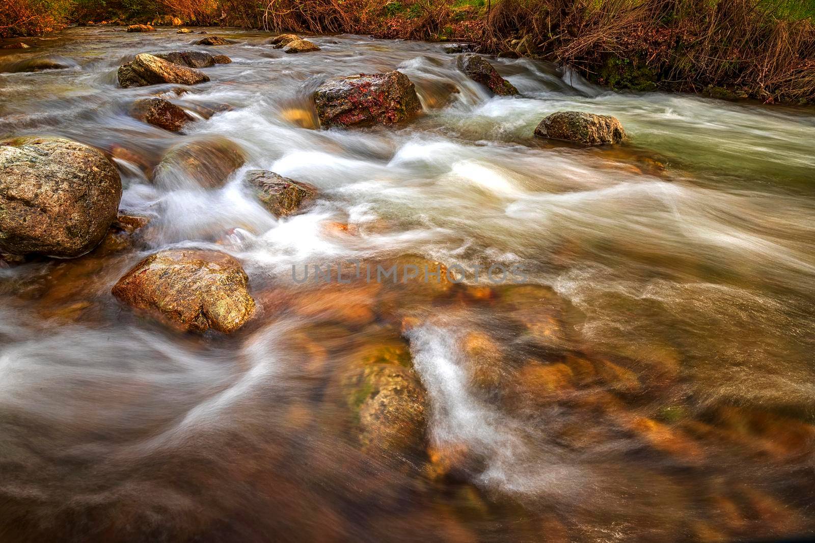 Beautiful autumn landscape of flowing water in mountain river  by EdVal